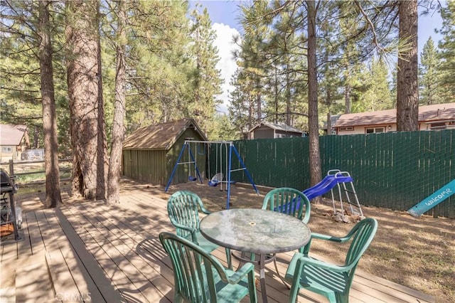 1100 Sugarloaf Blvd, Big Bear City, CA 92314 - wooden terrace with a playground, outdoor dining area, and a fenced backyard