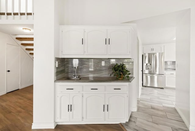 1295 Buenos Ave, San Diego, CA 92110 - kitchen featuring stainless steel fridge, a sink, white cabinetry, and backsplash