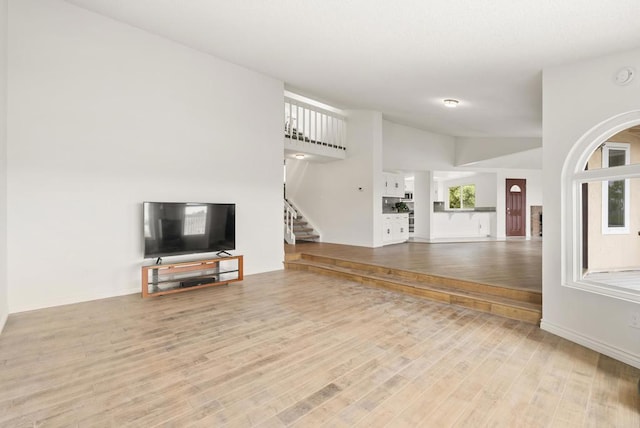 1295 Buenos Ave, San Diego, CA 92110 - unfurnished living room with wood finished floors, stairway, and baseboards