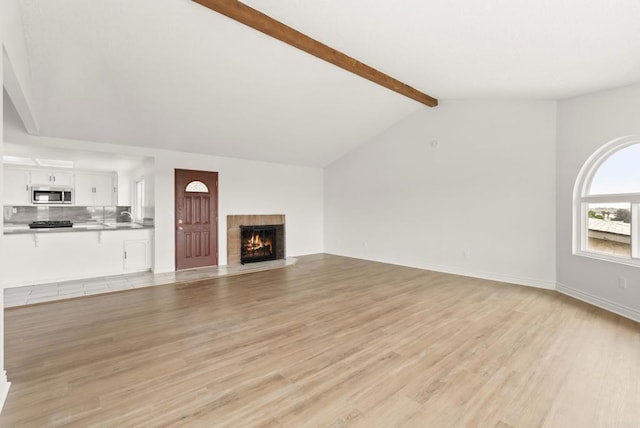 1295 Buenos Ave, San Diego, CA 92110 - unfurnished living room featuring a fireplace, light wood-style flooring, a sink, and baseboards