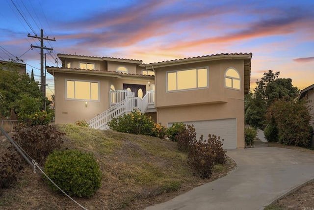 1295 Buenos Ave, San Diego, CA 92110 - view of front of property featuring stucco siding, an attached garage, driveway, stairs, and a tiled roof