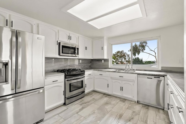 1295 Buenos Ave, San Diego, CA 92110 - kitchen featuring stainless steel appliances, a sink, and white cabinets