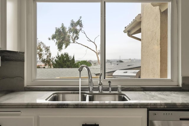 1295 Buenos Ave, San Diego, CA 92110 - kitchen with dishwasher, a sink, and white cabinetry