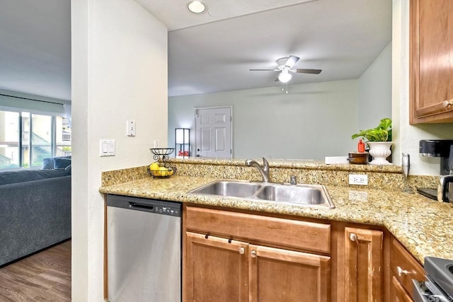145 W El Norte Pkwy Unit 123, Escondido, CA 92026 - kitchen with stainless steel dishwasher, a sink, ceiling fan, a peninsula, and wood finished floors