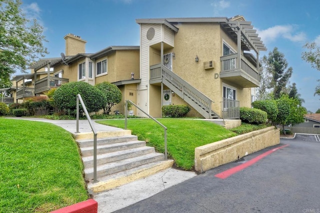 145 W El Norte Pkwy Unit 123, Escondido, CA 92026 - view of building exterior with stairway and a wall mounted air conditioner
