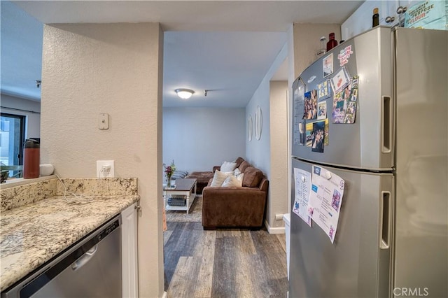 45 Stenner St Unit E, San Luis Obispo, CA 93405 - kitchen with appliances with stainless steel finishes, wood finished floors, a textured wall, light stone countertops, and open floor plan