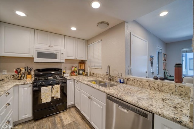 45 Stenner St Unit E, San Luis Obispo, CA 93405 - kitchen with black gas range, dishwasher, white microwave, a sink, and light wood-style floors