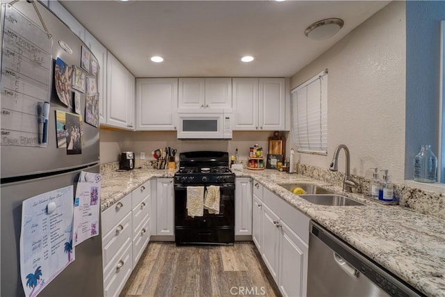 45 Stenner St Unit E, San Luis Obispo, CA 93405 - kitchen featuring freestanding refrigerator, white microwave, gas stove, dishwasher, and a sink