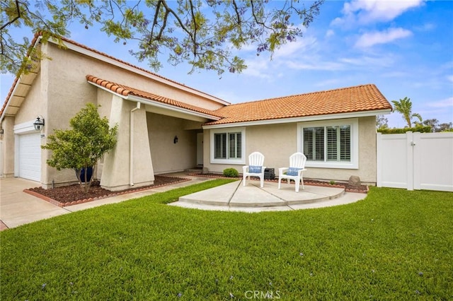 23291 Via Gaudix, Mission Viejo, CA 92691 - rear view of house featuring a tiled roof, stucco siding, concrete driveway, a garage, and a gate