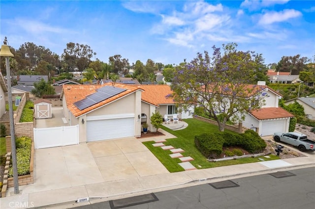 23291 Via Gaudix, Mission Viejo, CA 92691 - ranch-style house with a gate, roof mounted solar panels, driveway, a residential view, and a garage