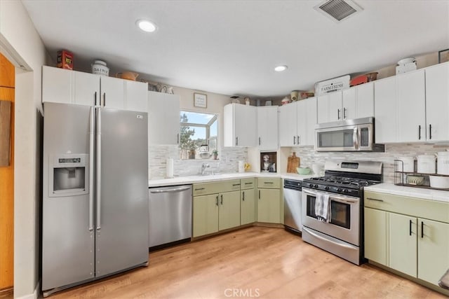 11029 Bel Air Ave, Ontario, CA 91762 - kitchen featuring stainless steel appliances, backsplash, light wood-style floors, recessed lighting, and green cabinetry