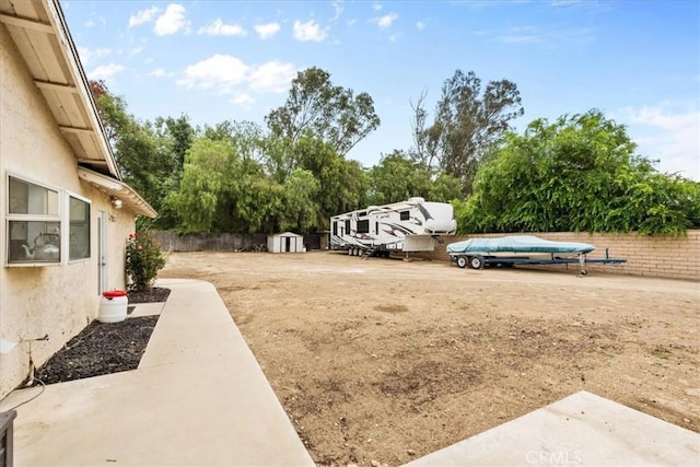 11029 Bel Air Ave, Ontario, CA 91762 - view of yard with a storage shed and view of wooded area