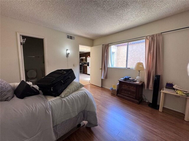 610 S Santa Fe St Unit 2, Hemet, CA 92543 - bedroom with wood finished floors, a textured ceiling, and baseboards