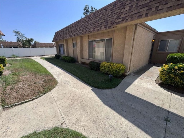 610 S Santa Fe St Unit 2, Hemet, CA 92543 - view of side of home with roof with shingles, mansard roof, stucco siding, and a patio