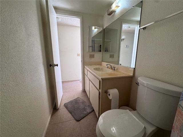 610 S Santa Fe St Unit 2, Hemet, CA 92543 - half bathroom with a textured wall, toilet, vanity, and tile patterned flooring