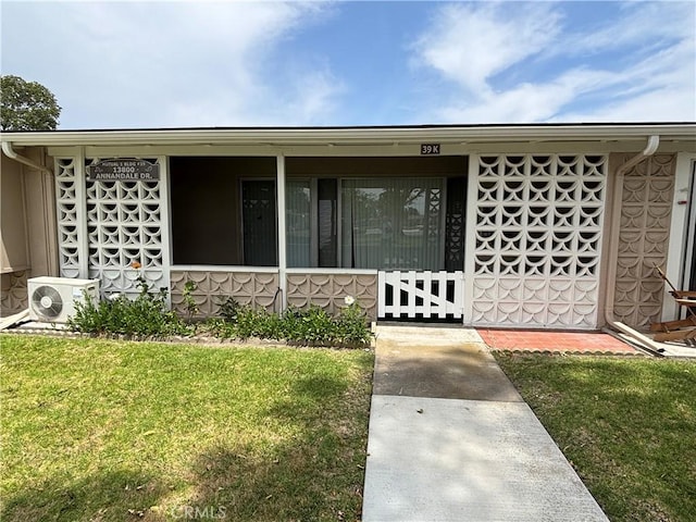 13800M1-39K Annandale Dr, Seal Beach, CA 90720 - property entrance with a cooling unit, a yard, and a porch