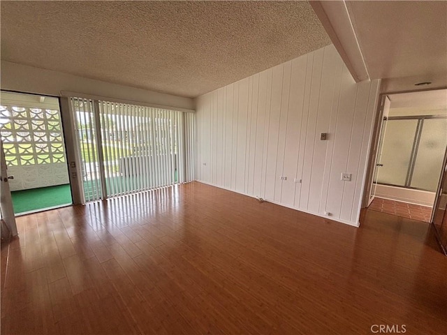 13800M1-39K Annandale Dr, Seal Beach, CA 90720 - unfurnished room featuring wood finished floors and a textured ceiling