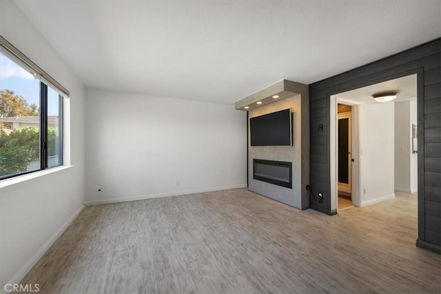 676 N 12th St Unit 3, Grover Beach, CA 93433 - unfurnished living room with a large fireplace, wood finished floors, and baseboards