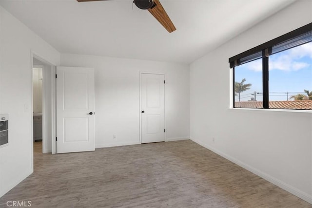 676 N 12th St Unit 3, Grover Beach, CA 93433 - unfurnished bedroom with wood finished floors, baseboards, and ceiling fan