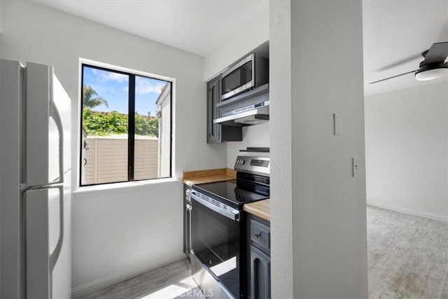 676 N 12th St Unit 3, Grover Beach, CA 93433 - kitchen featuring stainless steel appliances, extractor fan, light wood-type flooring, baseboards, and a ceiling fan