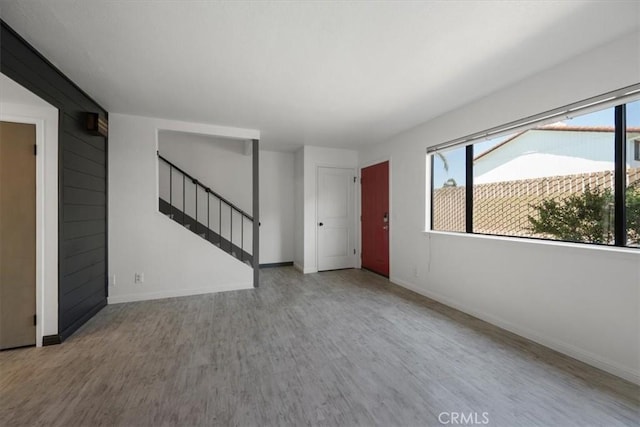 676 N 12th St Unit 3, Grover Beach, CA 93433 - unfurnished living room with wood finished floors, stairs, and baseboards