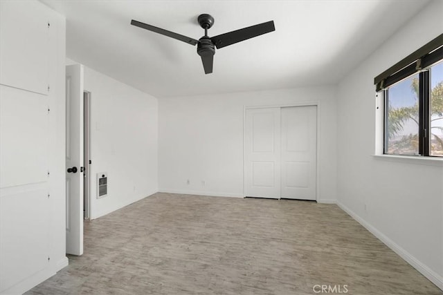 676 N 12th St Unit 3, Grover Beach, CA 93433 - unfurnished bedroom with light wood-style floors, baseboards, a closet, ceiling fan, and heating unit