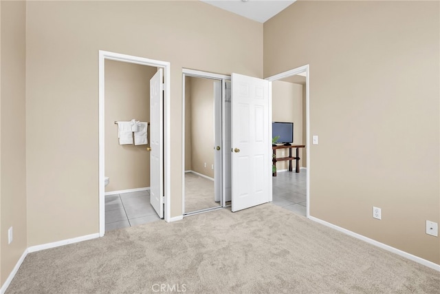 11868 Amethyst Ct, Jurupa Valley, CA 91752 - unfurnished bedroom featuring carpet floors, baseboards, tile patterned flooring, connected bathroom, and a closet