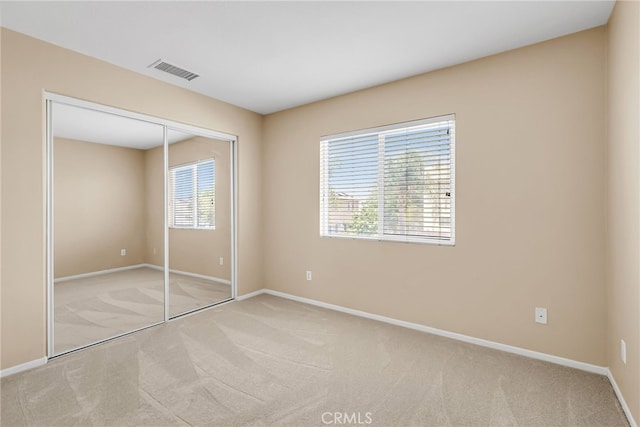 11868 Amethyst Ct, Jurupa Valley, CA 91752 - unfurnished bedroom featuring light carpet, baseboards, and a closet