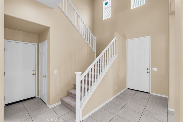 11868 Amethyst Ct, Jurupa Valley, CA 91752 - foyer entrance with tile patterned flooring, stairway, a towering ceiling, and baseboards