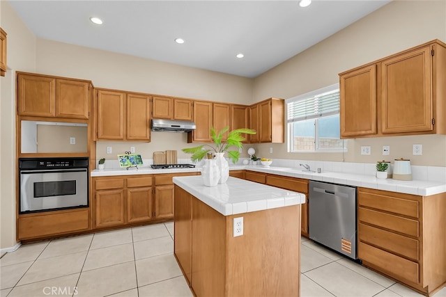 11868 Amethyst Ct, Jurupa Valley, CA 91752 - kitchen with appliances with stainless steel finishes, under cabinet range hood, tile counters, a sink, and recessed lighting