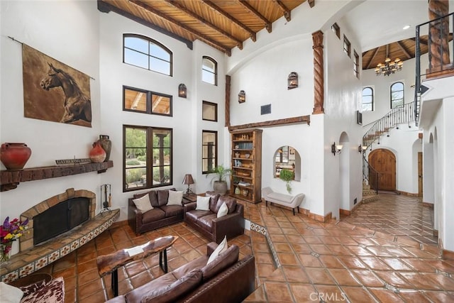 4950 Davenport Creek Rd, San Luis Obispo, CA 93401 - living room featuring a wood ceiling with exposed beams, arched walkways, a high ceiling, healthy amount of natural light, and a fireplace with raised hearth