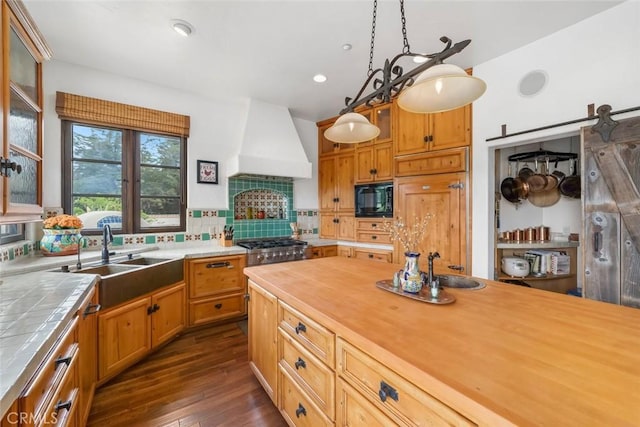 4950 Davenport Creek Rd, San Luis Obispo, CA 93401 - kitchen with black microwave, custom range hood, dark wood-style floors, glass insert cabinets, and decorative backsplash