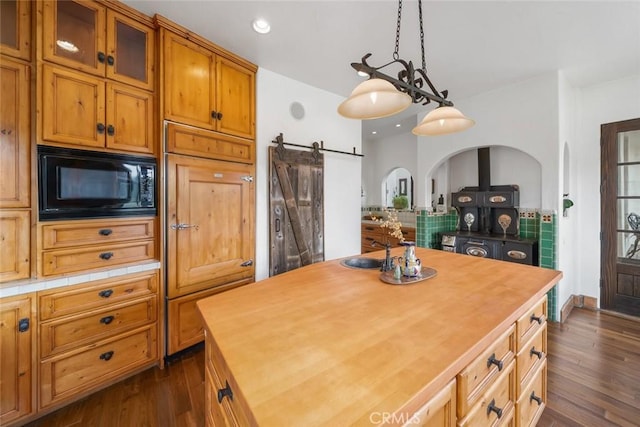 4950 Davenport Creek Rd, San Luis Obispo, CA 93401 - kitchen featuring black microwave, butcher block countertops, dark wood-style flooring, glass insert cabinets, and recessed lighting