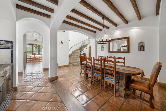 4950 Davenport Creek Rd, San Luis Obispo, CA 93401 - dining room with a chandelier, arched walkways, stairs, beam ceiling, and light tile patterned floors