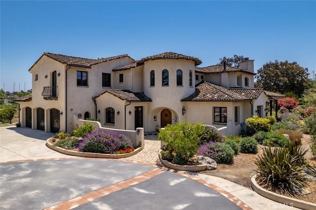 4950 Davenport Creek Rd, San Luis Obispo, CA 93401 - mediterranean / spanish-style house with an attached garage, stucco siding, concrete driveway, and a chimney