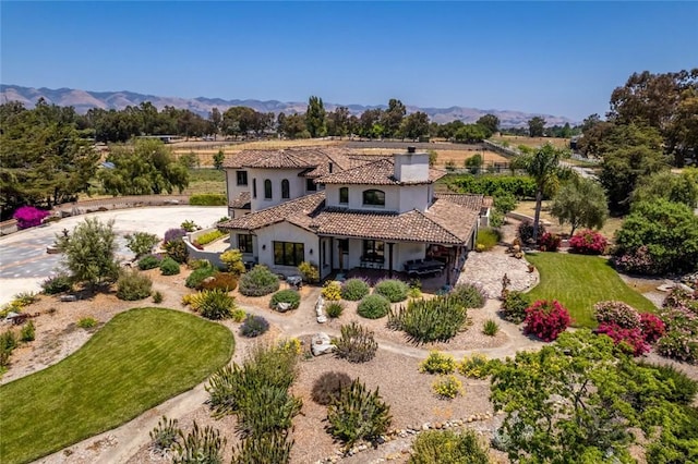 4950 Davenport Creek Rd, San Luis Obispo, CA 93401 - view of front facade with stucco siding, curved driveway, a tiled roof, a mountain view, and a chimney