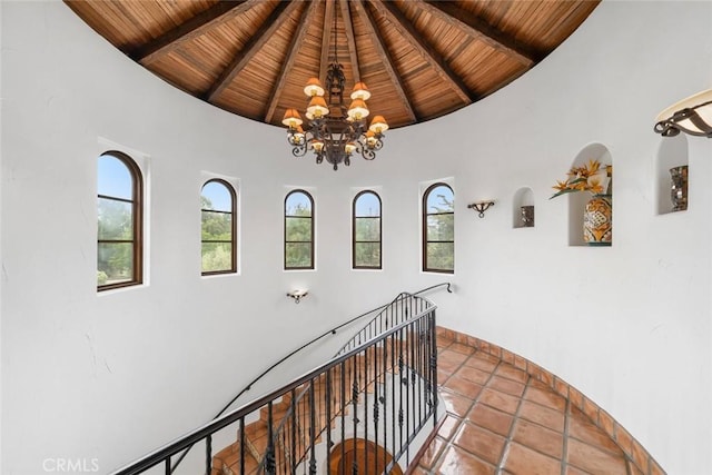 4950 Davenport Creek Rd, San Luis Obispo, CA 93401 - hall with a wooden ceiling with exposed beams, a chandelier, high vaulted ceiling, and an upstairs landing