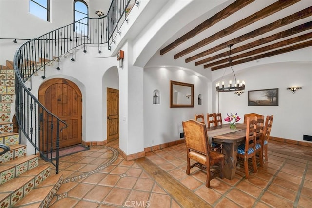 4950 Davenport Creek Rd, San Luis Obispo, CA 93401 - dining room with arched walkways, stairway, a chandelier, and beam ceiling