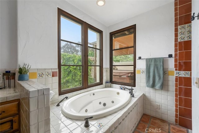 4950 Davenport Creek Rd, San Luis Obispo, CA 93401 - full bath featuring a tub with jets, tile walls, and tile patterned floors