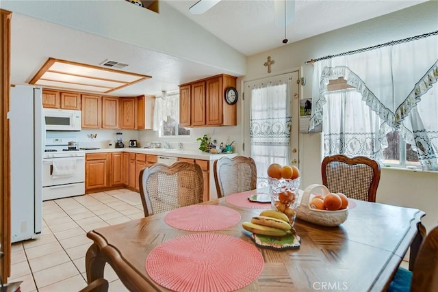21919 Standing Rock Ave, Apple Valley, CA 92307 - dining area featuring light tile patterned floors, vaulted ceiling, and ceiling fan