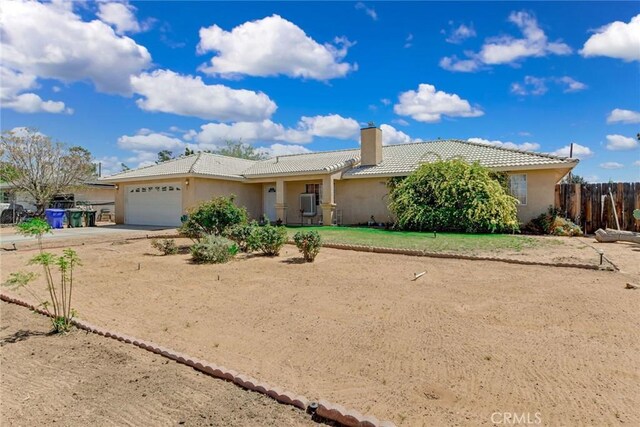 21919 Standing Rock Ave, Apple Valley, CA 92307 - ranch-style house with a chimney, a garage, concrete driveway, and stucco siding