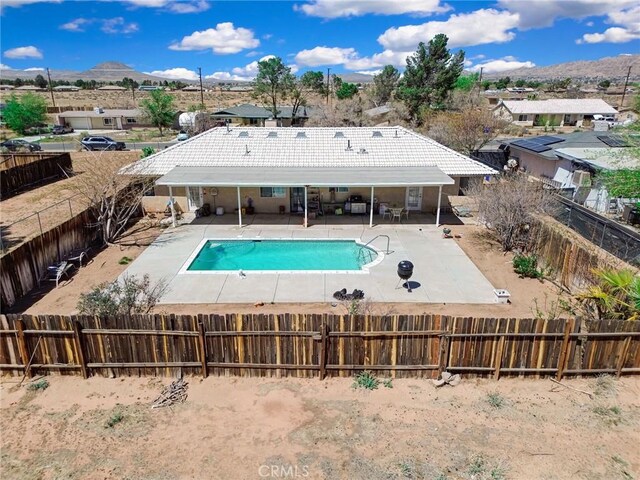 21919 Standing Rock Ave, Apple Valley, CA 92307 - view of swimming pool featuring a fenced backyard, a patio, a mountain view, and a residential view