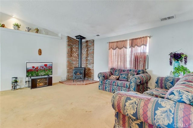 21919 Standing Rock Ave, Apple Valley, CA 92307 - living room with a wood stove and carpet flooring