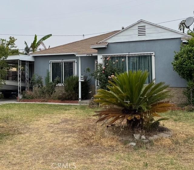8261 Samoline Ave, Pico Rivera, CA 90660 - view of front facade with stucco siding and a front lawn