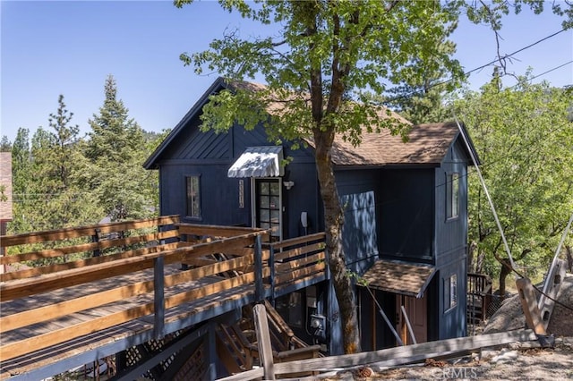 33310 Conway Dr, Running Springs, CA 92308 - view of front of home with a wooden deck, stairs, and a shingled roof