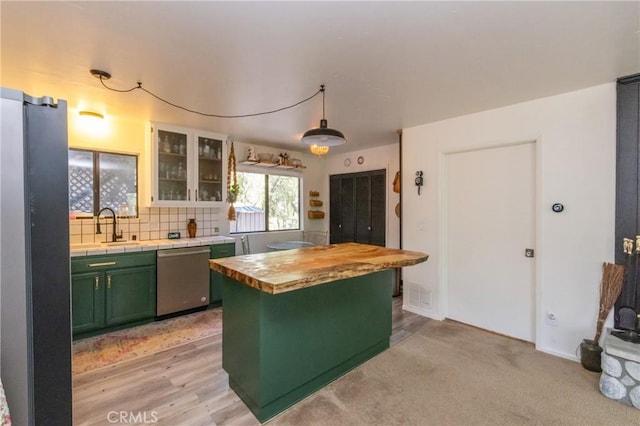 33310 Conway Dr, Running Springs, CA 92308 - kitchen with stainless steel dishwasher, green cabinetry, freestanding refrigerator, a sink, and butcher block counters