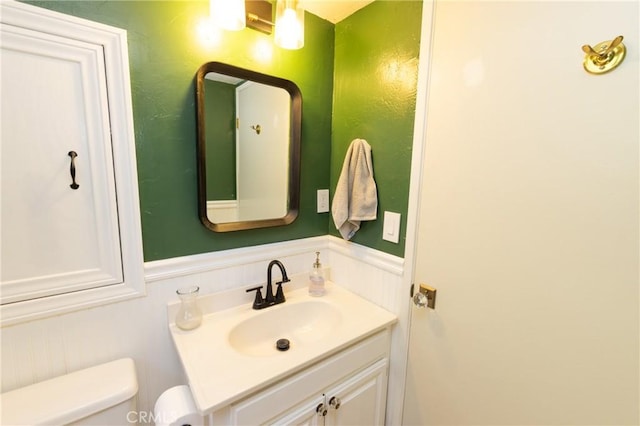 33310 Conway Dr, Running Springs, CA 92308 - bathroom featuring toilet, vanity, and a wainscoted wall