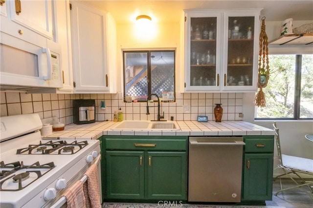 33310 Conway Dr, Running Springs, CA 92308 - kitchen featuring white appliances, a sink, white cabinetry, green cabinets, and tasteful backsplash