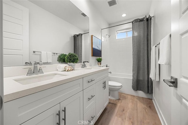 121 Biome, Irvine, CA 92618 - full bathroom with double vanity, toilet, shower / tub combo with curtain, wood finished floors, and recessed lighting