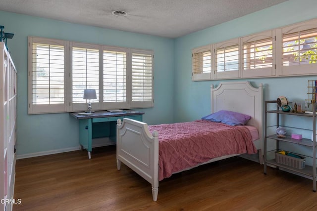 85 Gardenia Ct, Upland, CA 91786 - bedroom featuring wood finished floors, a textured ceiling, and baseboards